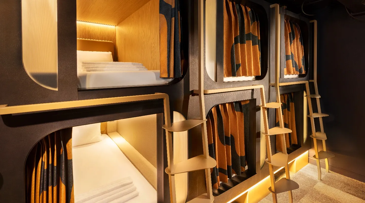 A Kabannas dormitory showing cosy Pods in soft lighting
