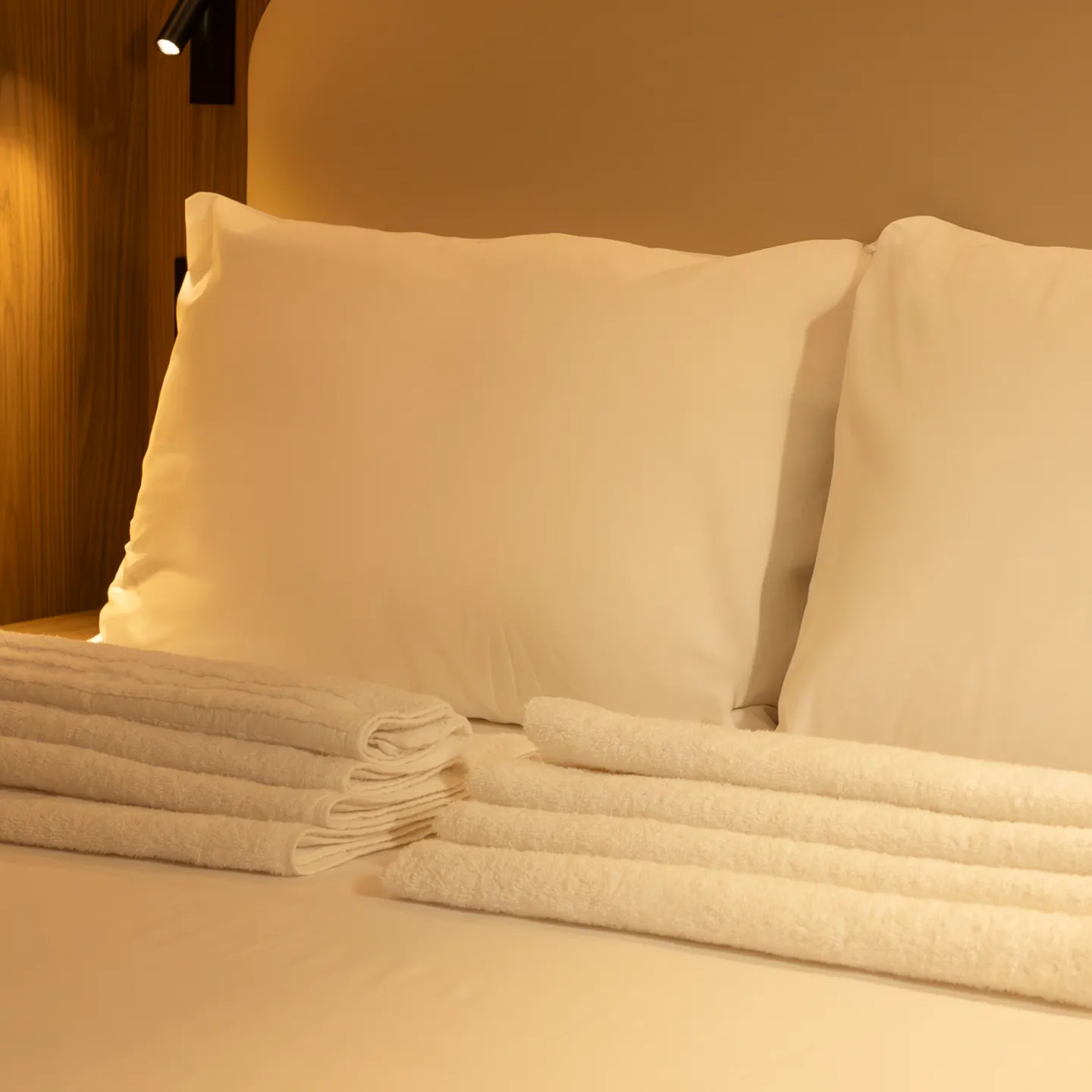 A Kabannas Nest room showing the warm and cosy interior with crisp white sheets