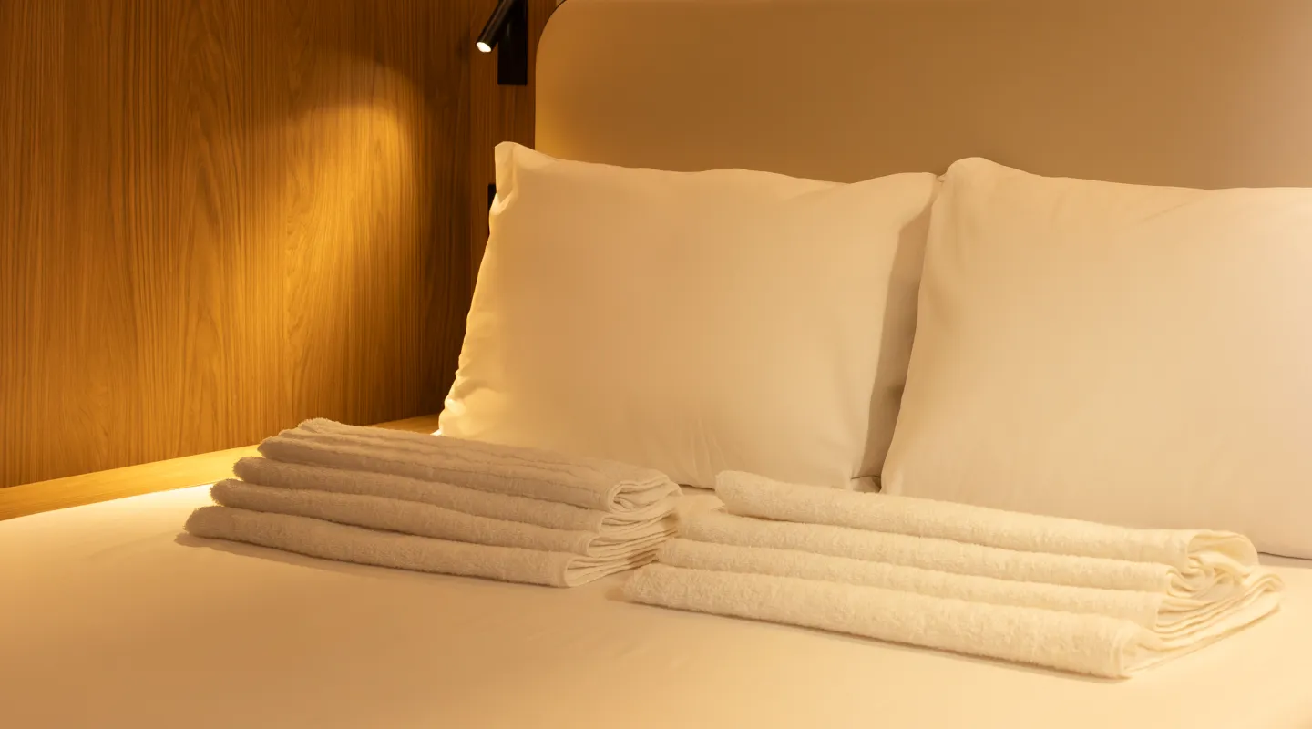 A close up of a clean and cosy bed in a Kabannas Nest room
