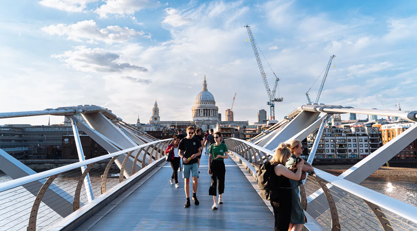 People walking across London's Millennium Bridge